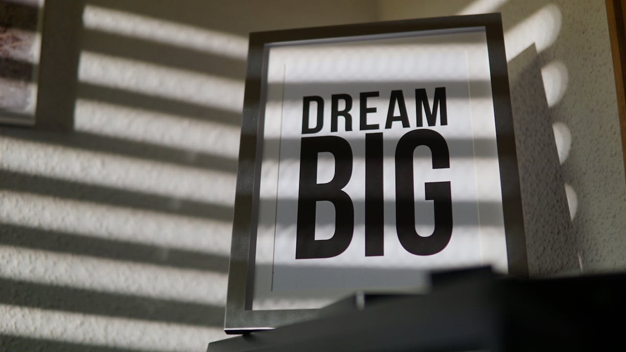 Framed motivational Dream Big text art creates an inspiring indoor ambiance.